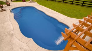C40 pool with shade structure and rain fall water feature.