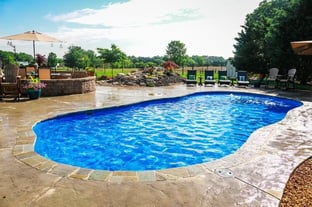 C40 with spacious stamped concrete deck and natural stone coping