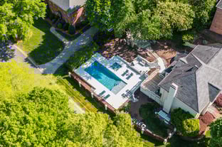 River Pools D40 + SS08 in Diamond with cascades, bubblers, and natural stone patio and coping