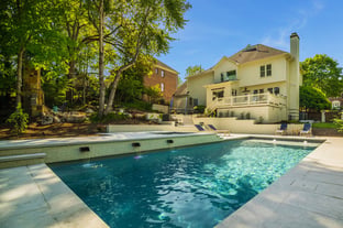 River Pools D40 + SS08 in Diamond with cascades, bubblers, and natural stone patio and coping