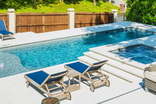 River Pools D40 + SS08 in Diamond with cascades, bubblers, and natural stone patio and coping