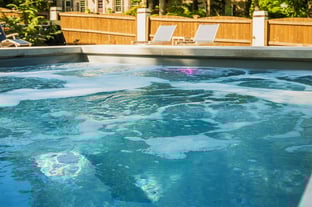 River Pools D40 in Diamond with cascades, bubblers, and natural stone patio and coping