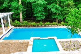 River Pools fiberglass pool with a tanning ledge in California Shimmer color