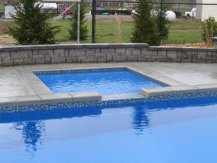 8x8 River Pools tanning ledge with spillway into G36 fiberglass pool Maya Blue