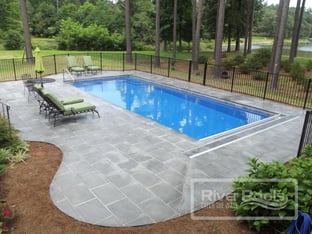 G36 with bluestone patio, automatic pool cover, and aluminum pool fencing. Pool color is Maya Blue