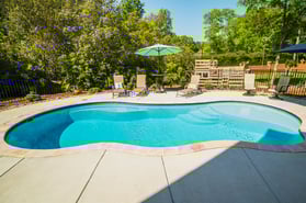 016. River Pools I30 in Caribbean Sparkle with brushed concrete and natural stone coping