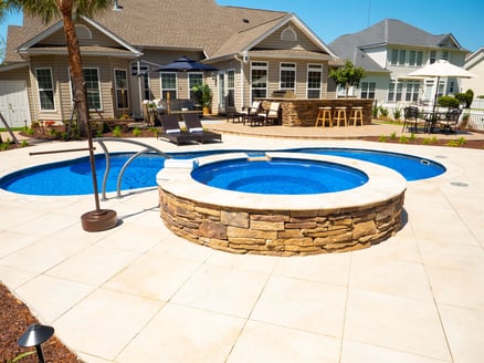 015. River Pools I30 + RS08 with spillway in Maya Shimmer with natural stone patio and coping