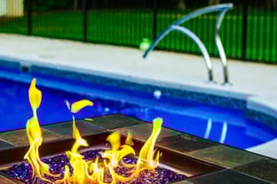 Relax in by the fire on the tanning ledge of our L36 pool
