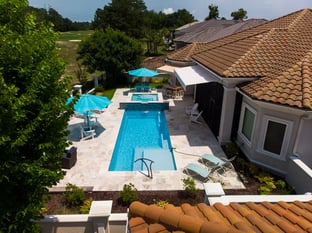  River Pools M30 + SS08 with spillway in Caribbean Sparkle with natural stone patio and coping