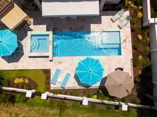  River Pools M30 + SS08 with spillway in Caribbean Sparkle with natural stone patio and coping