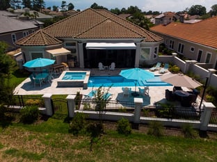  River Pools M30 + SS08 with spillway in Caribbean Sparkle with natural stone patio and coping