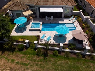  River Pools M30 + SS08 with spillway in Caribbean Sparkle with natural stone patio and coping