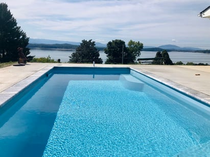 002. R Series in Caribbean with travertine coping and brushed concrete decking