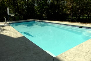 R36 pool in Arctic with textured concrete deck and waterline tile