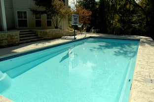 R36 pool in Arctic with textured concrete deck and waterline tile