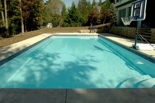 R36 pool in Arctic with textured concrete deck and waterline tile