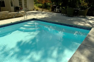 R36 pool in Arctic with textured concrete deck and waterline tile