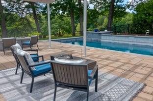 River Pools X36 in Diamond color with cascade, concrete paver patio, and natural stone coping