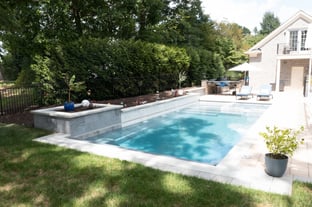 River Pools X36 in Diamond color with cascade, concrete paver patio, and natural stone coping