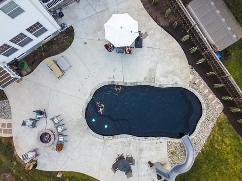 Inground pool slide with freeform fiberglass pool