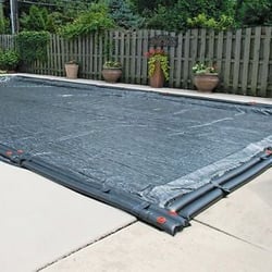 Tarp-style winter cover for a pool