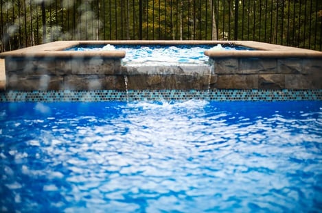 Close up of spa with spillover spilling into pool