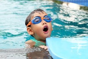 child wearing goggles in a pool