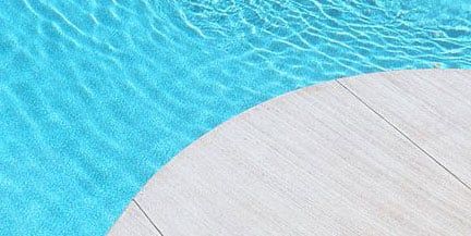 Brushed concrete finish installed for inground fiberglass pool.