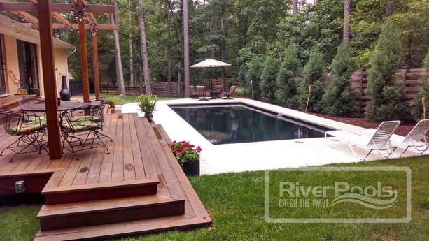 dark bottom swimming pool with wood deck