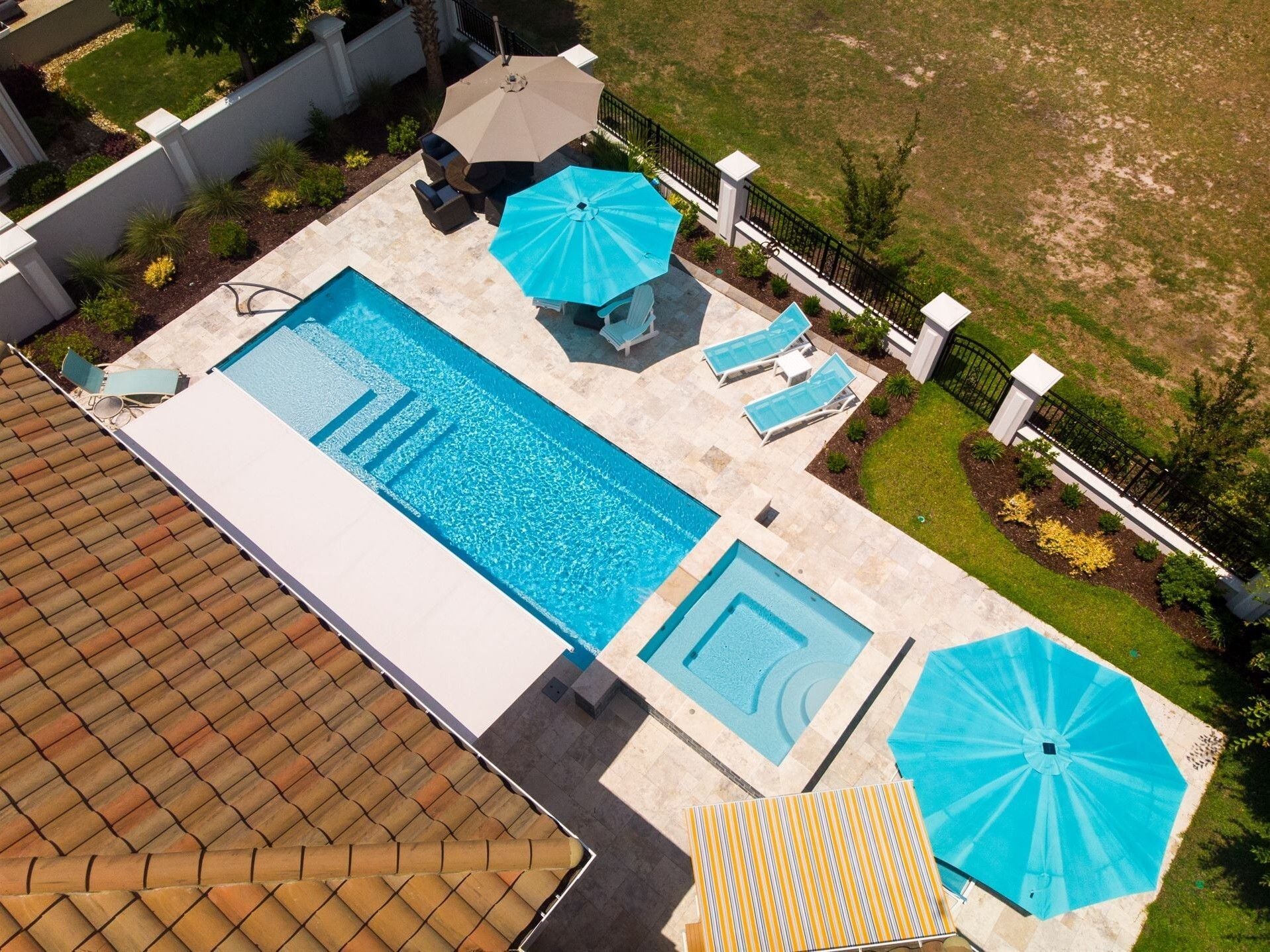 007. River Pools M30 + SS08 with spillway in Caribbean Sparkle with natural stone patio and coping 007. River Pools M30 + SS08 with spillway in Caribbean Sparkle with natural stone patio and coping