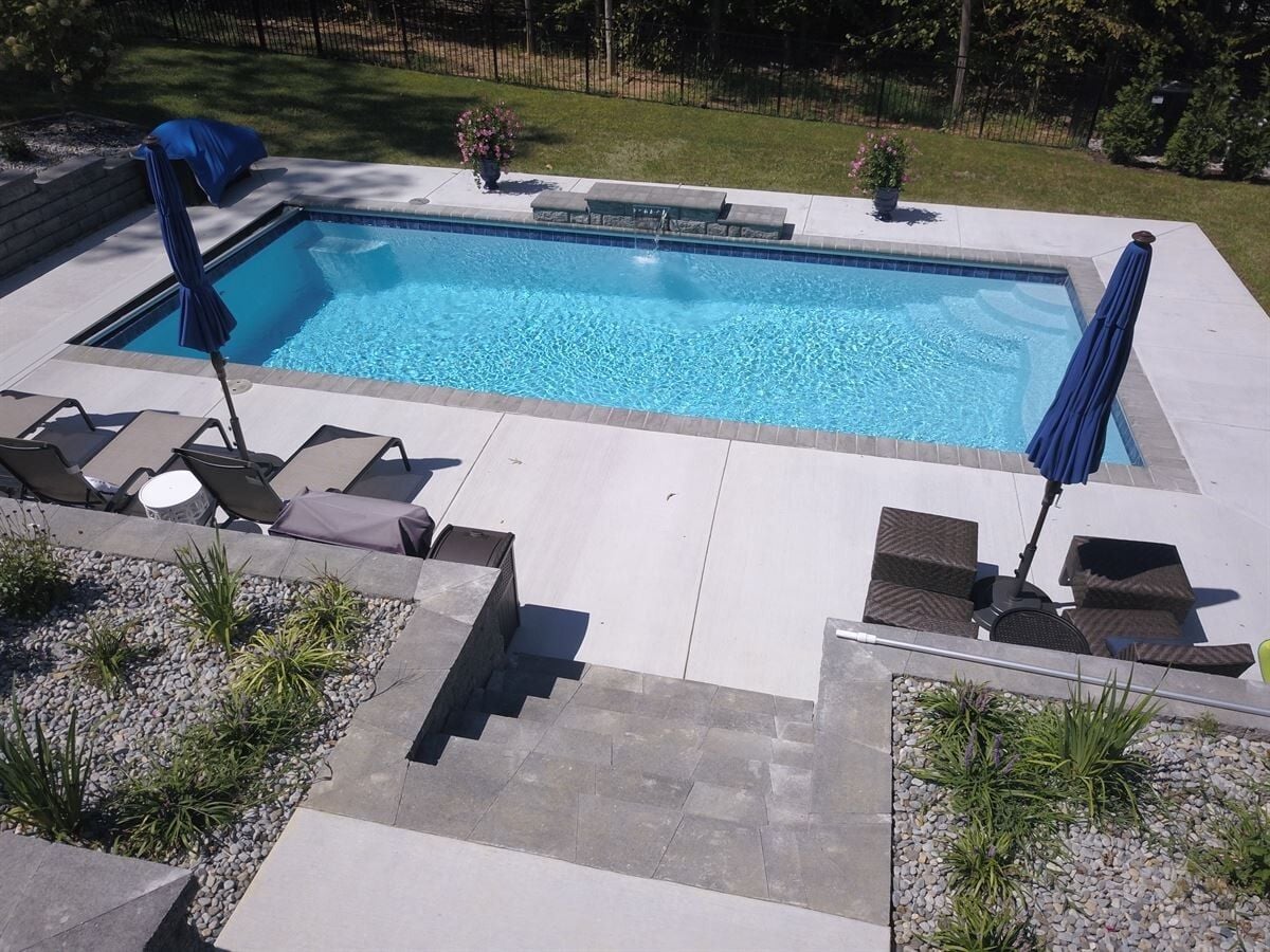 011. R32 pool in Caribbean with paver coping and brushed concrete decking featuring a cascade water feature-1 011. R32 pool in Caribbean with paver coping and brushed concrete decking featuring a cascade water feature-1