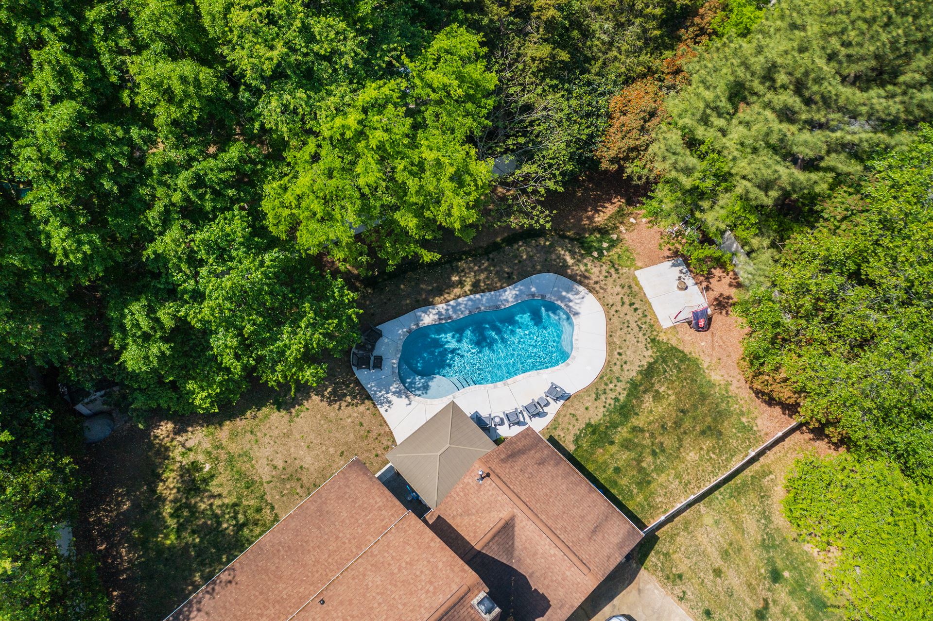 River Pools C35 in Diamond color with brushed concrete and natural stone coping