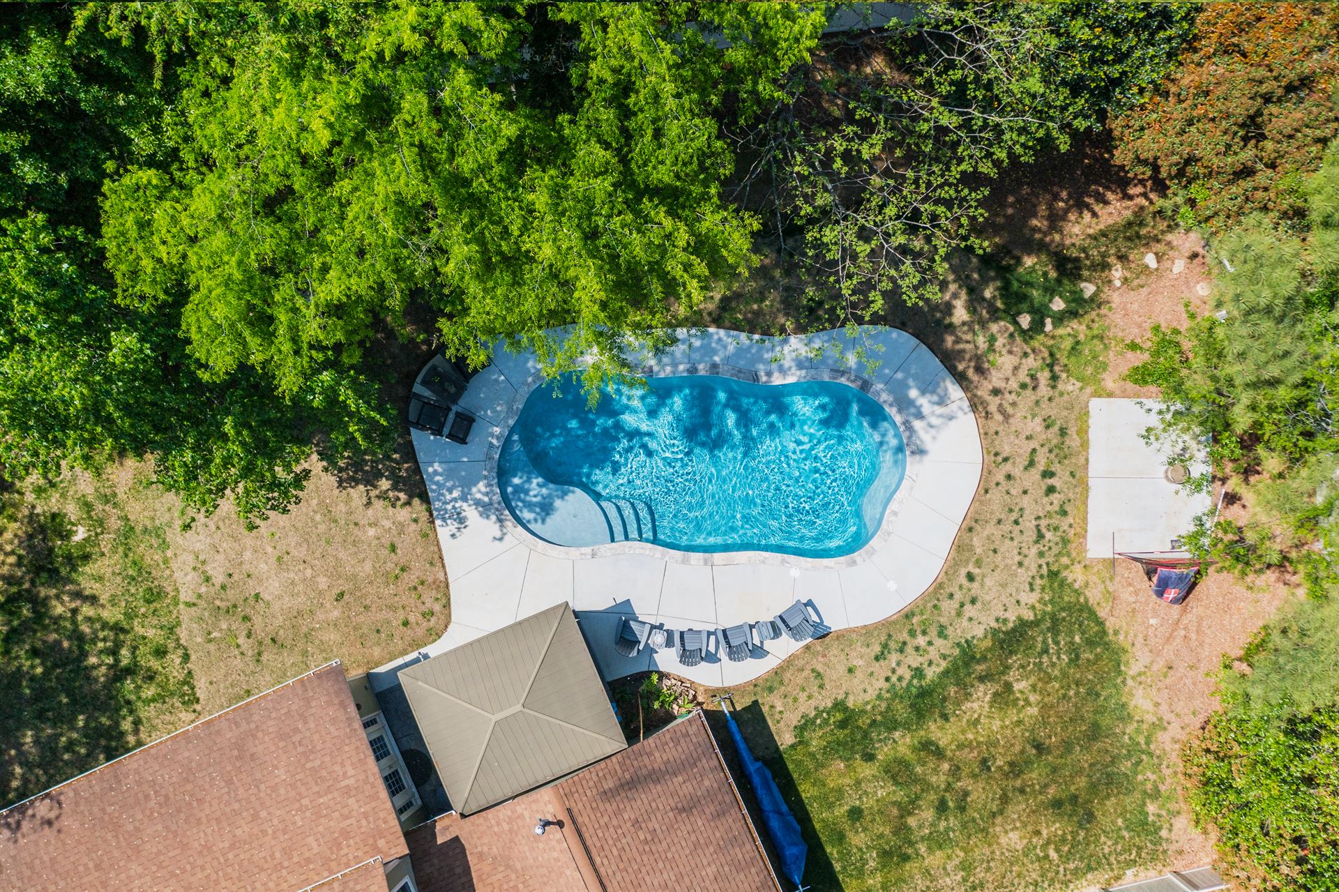 River Pools C35 in Diamond color with brushed concrete and natural stone coping