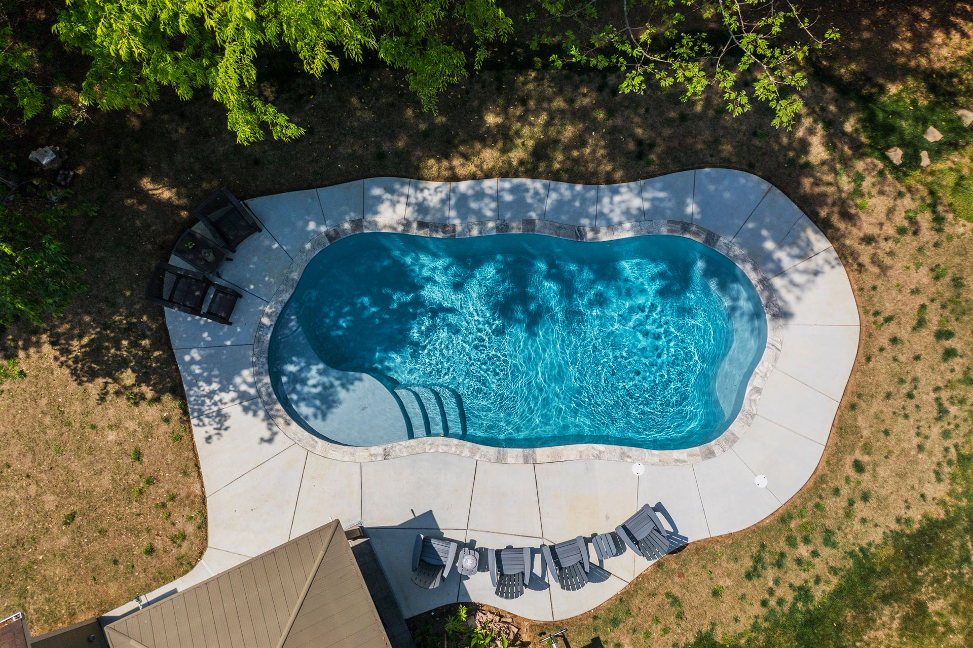 River Pools C35 in Diamond color with brushed concrete and natural stone coping