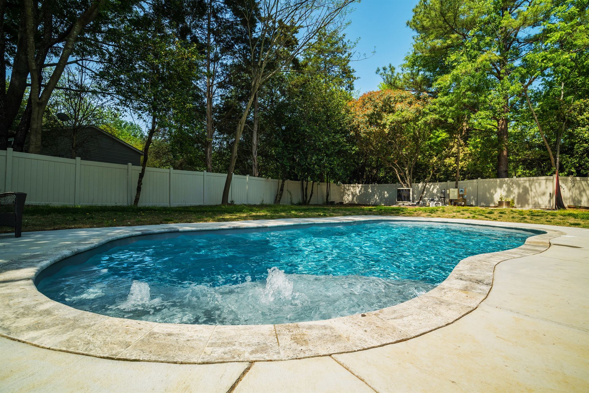 River Pools C35 in Diamond color with bubbler, brushed concrete and natural stone coping