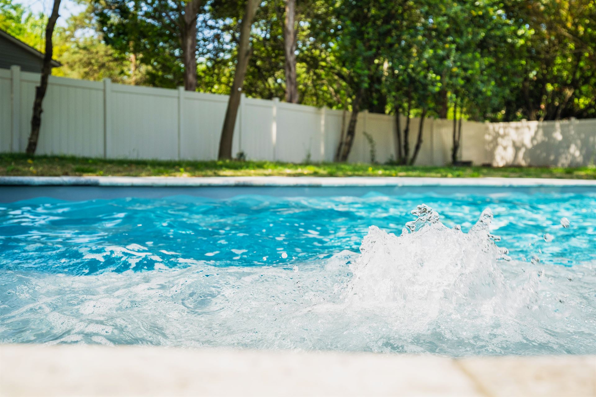 River Pools C35 in Diamond color with bubblers, brushed concrete and natural stone coping