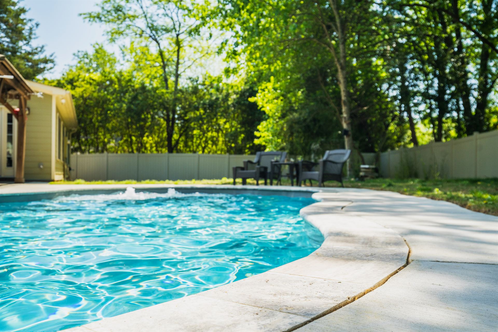 River Pools C35 in Diamond color with bubblers, brushed concrete and natural stone coping