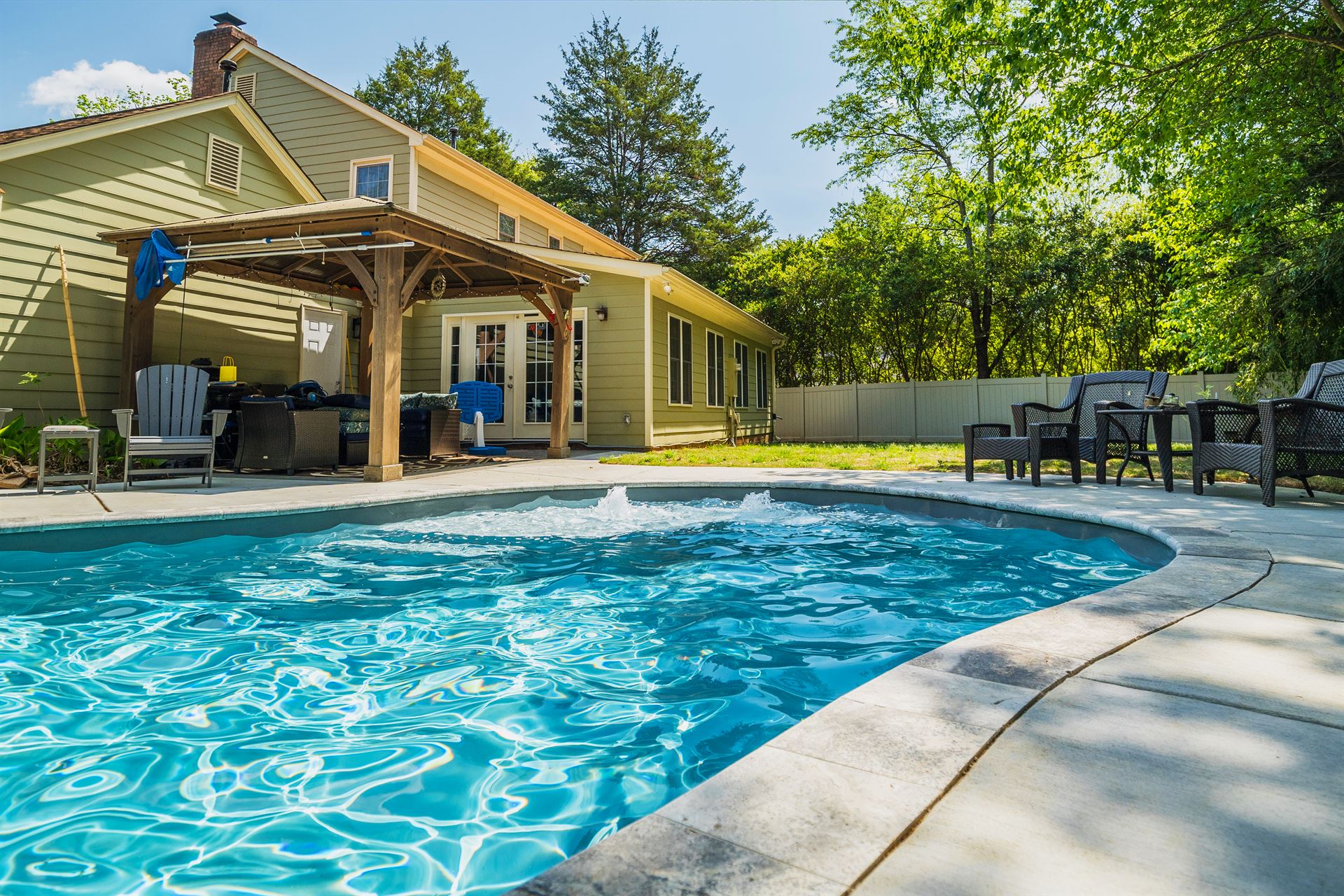 River Pools C35 in Granite Gray with bubblers, brushed concrete and natural stone coping