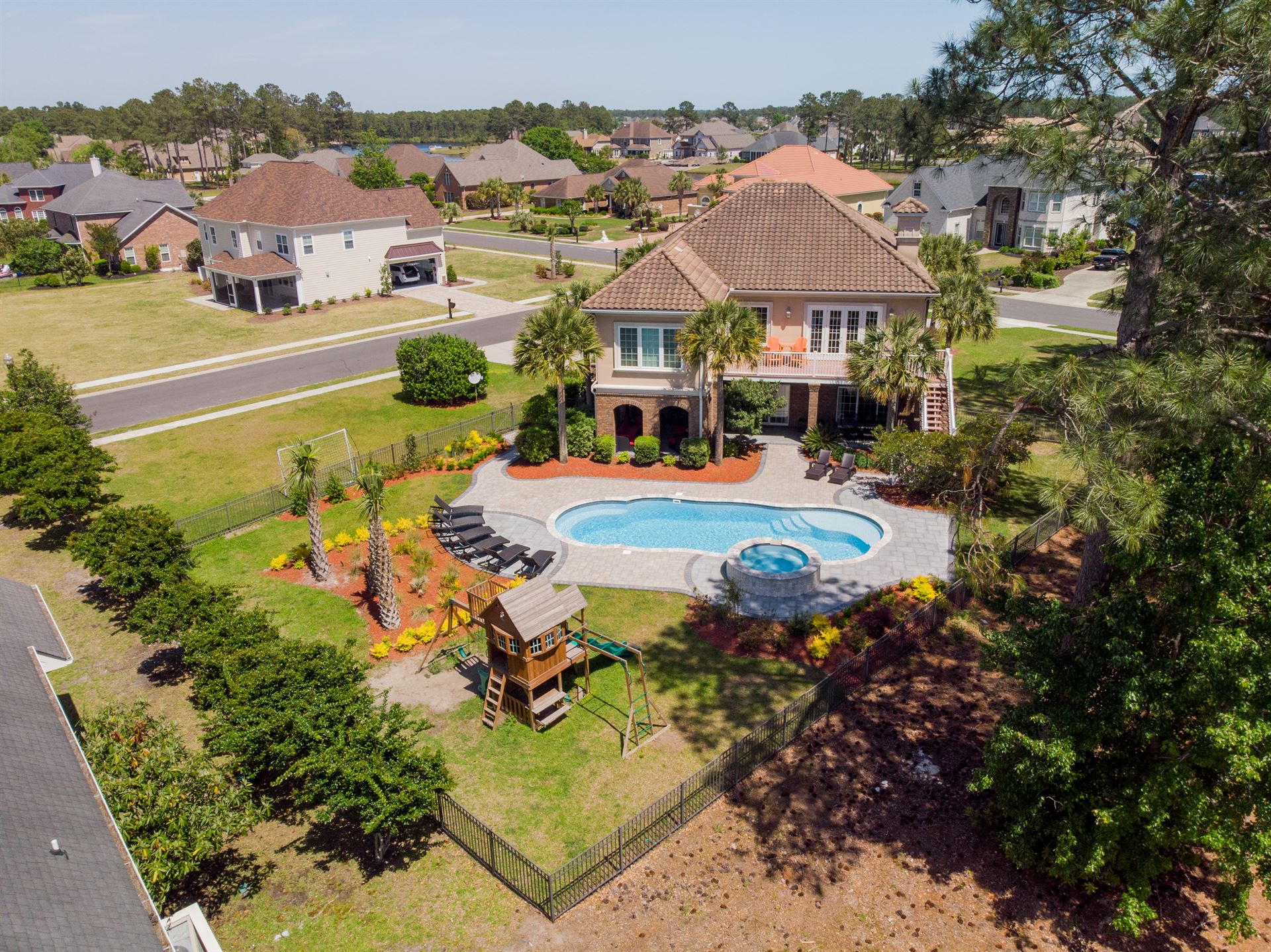 River Pools C40 + RS08 with spillway in Caribbean Sparkle with concrete paver patio and natural stone coping