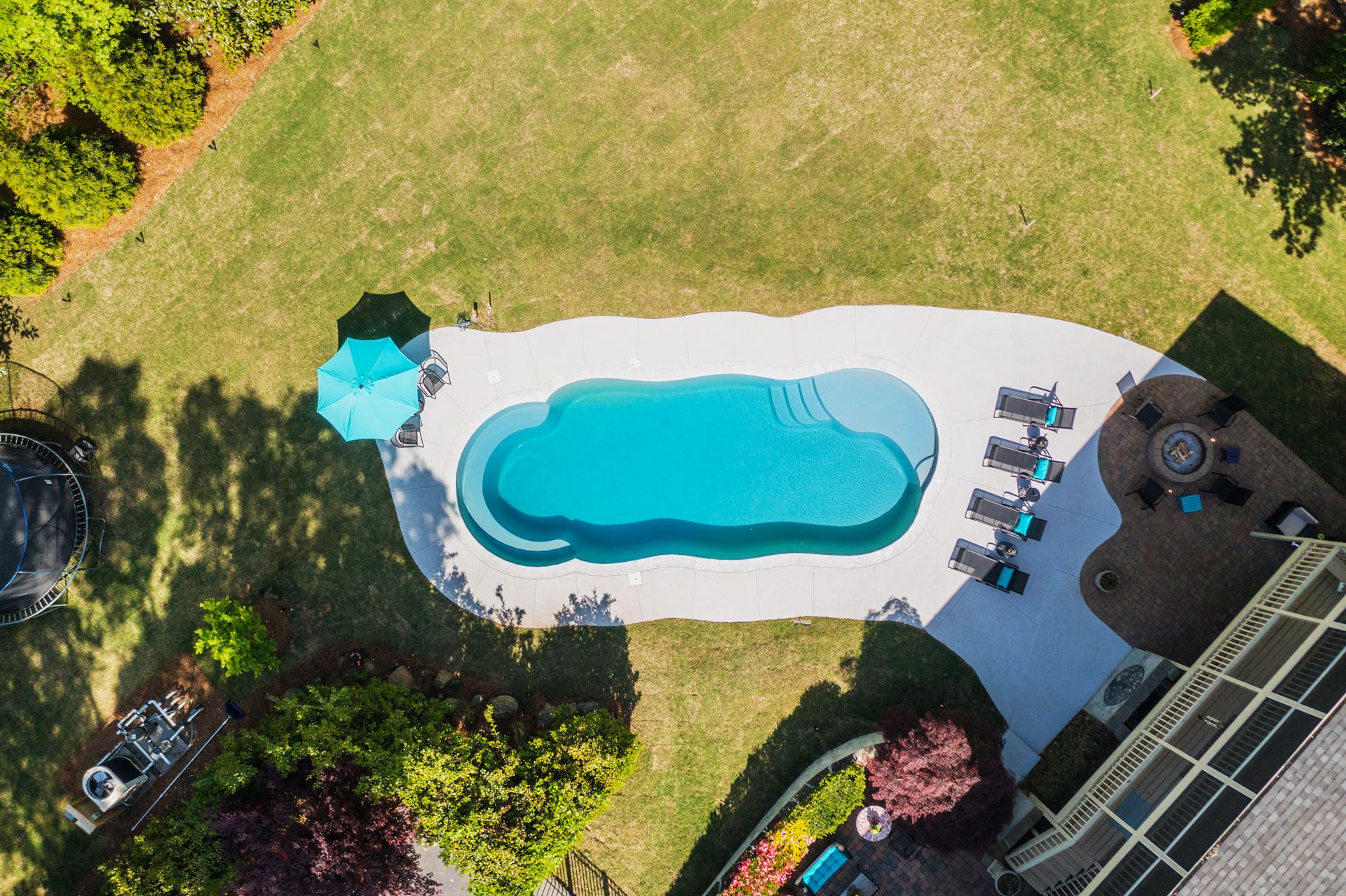 River Pools C40 in Granite Gray with brushed concrete and natural stone coping