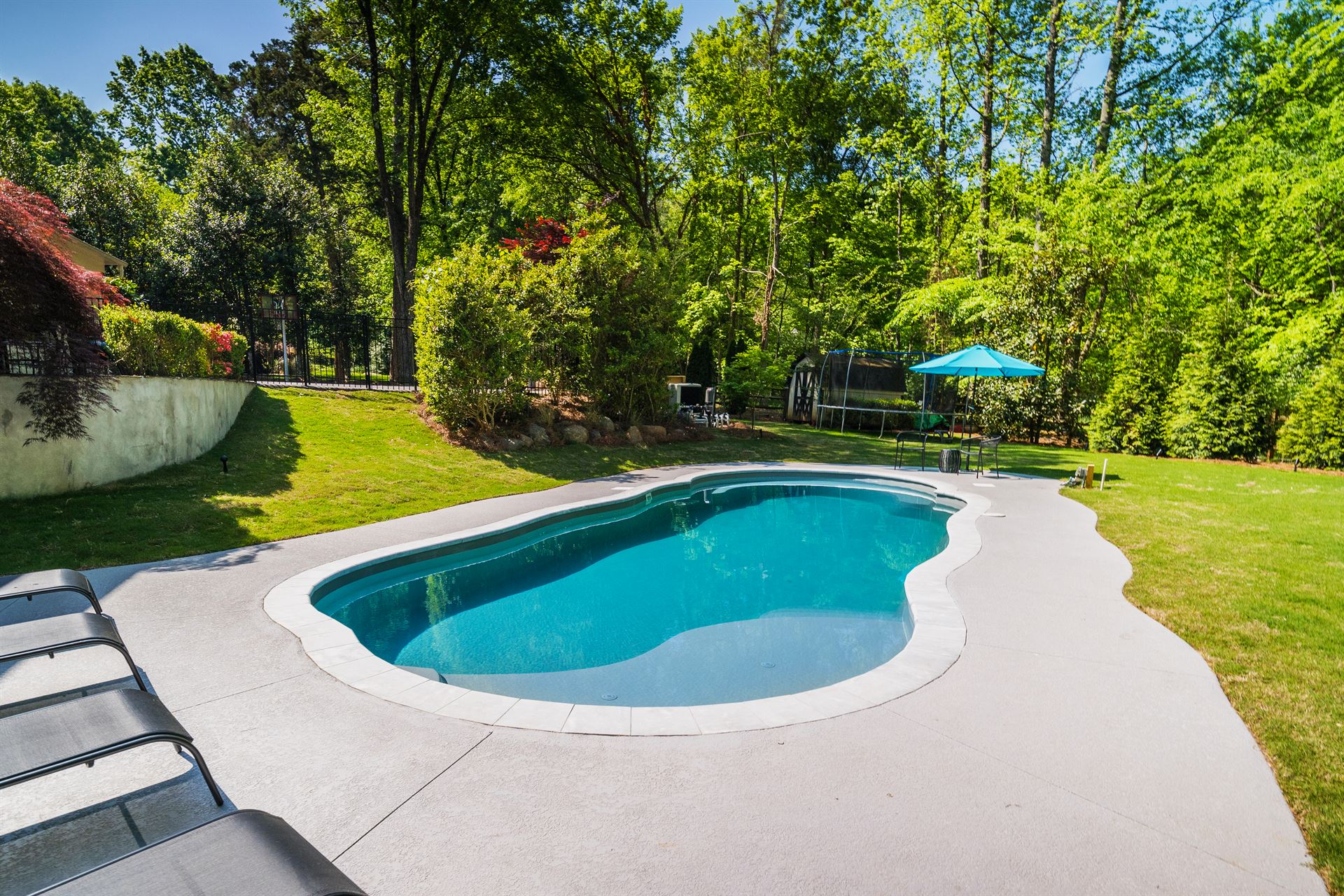 River Pools C40 in Granite Gray with brushed concrete and natural stone coping