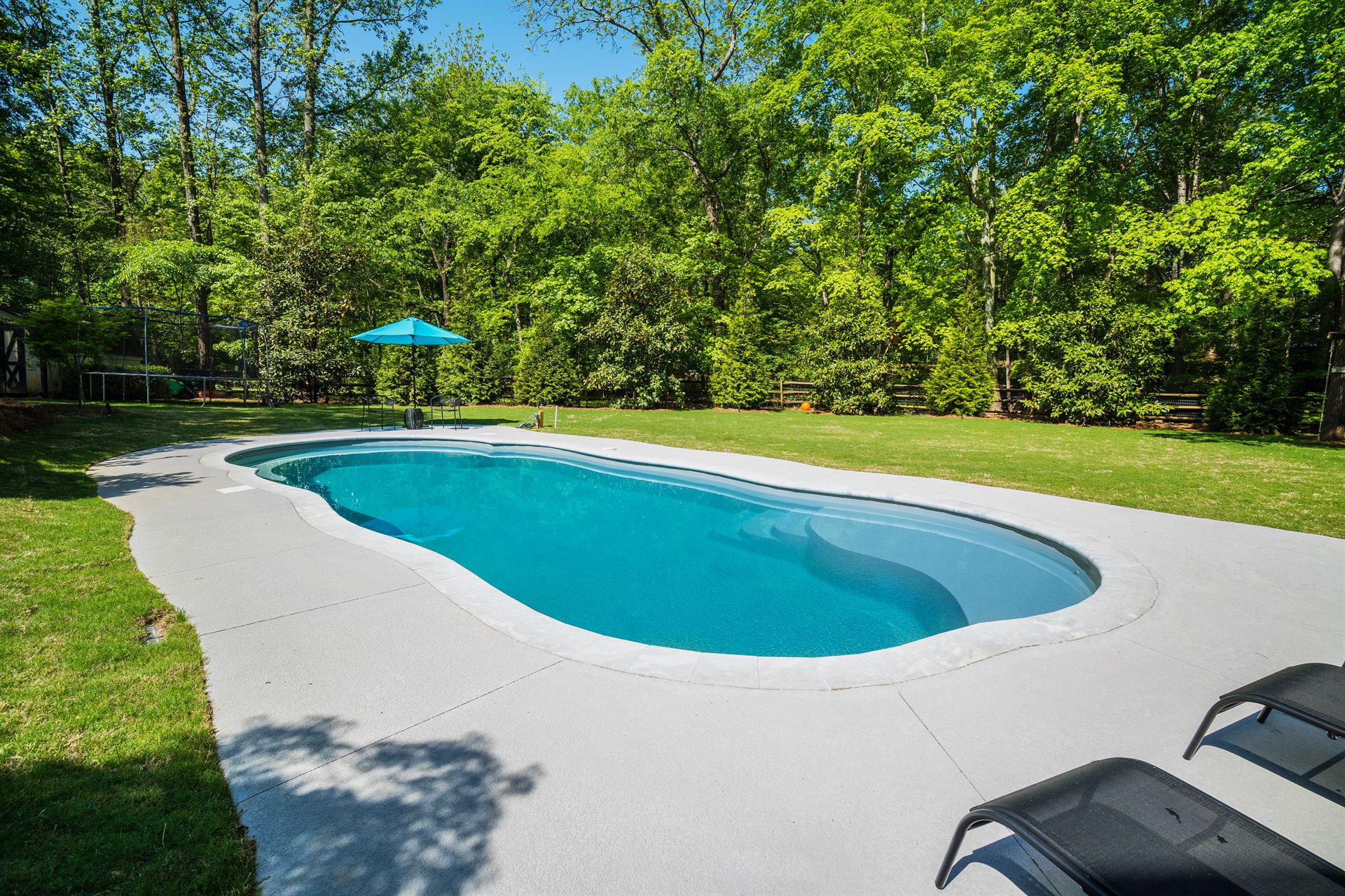 River Pools C40 in Granite Gray with brushed concrete and natural stone coping