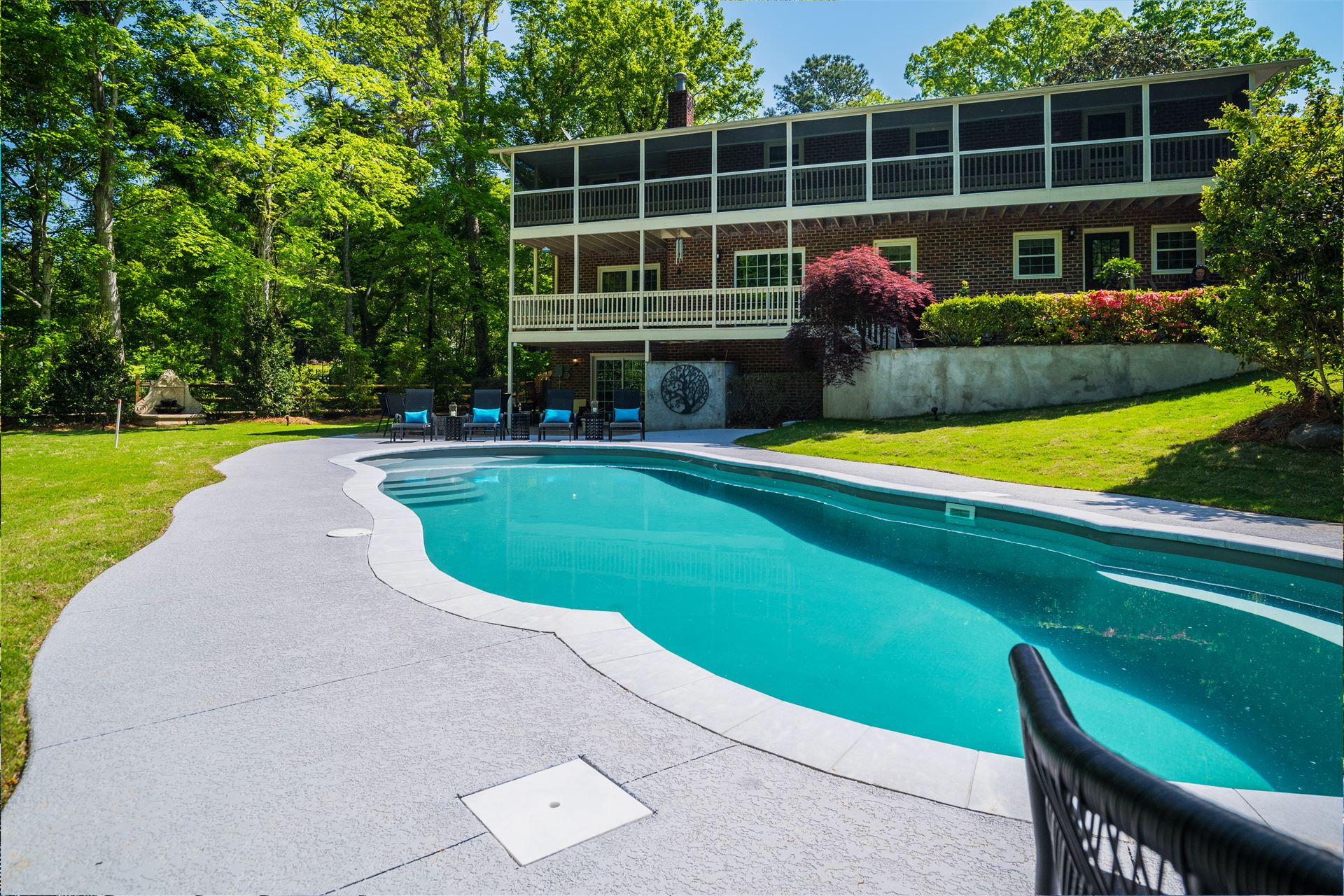 River Pools C40 in Diamond color with brushed concrete and natural stone coping