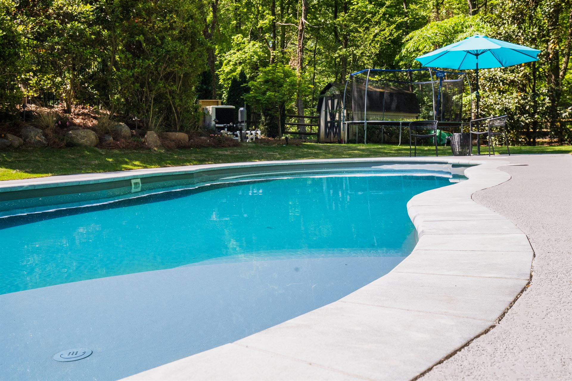 River Pools C40 in Granite Gray with brushed concrete and natural stone coping