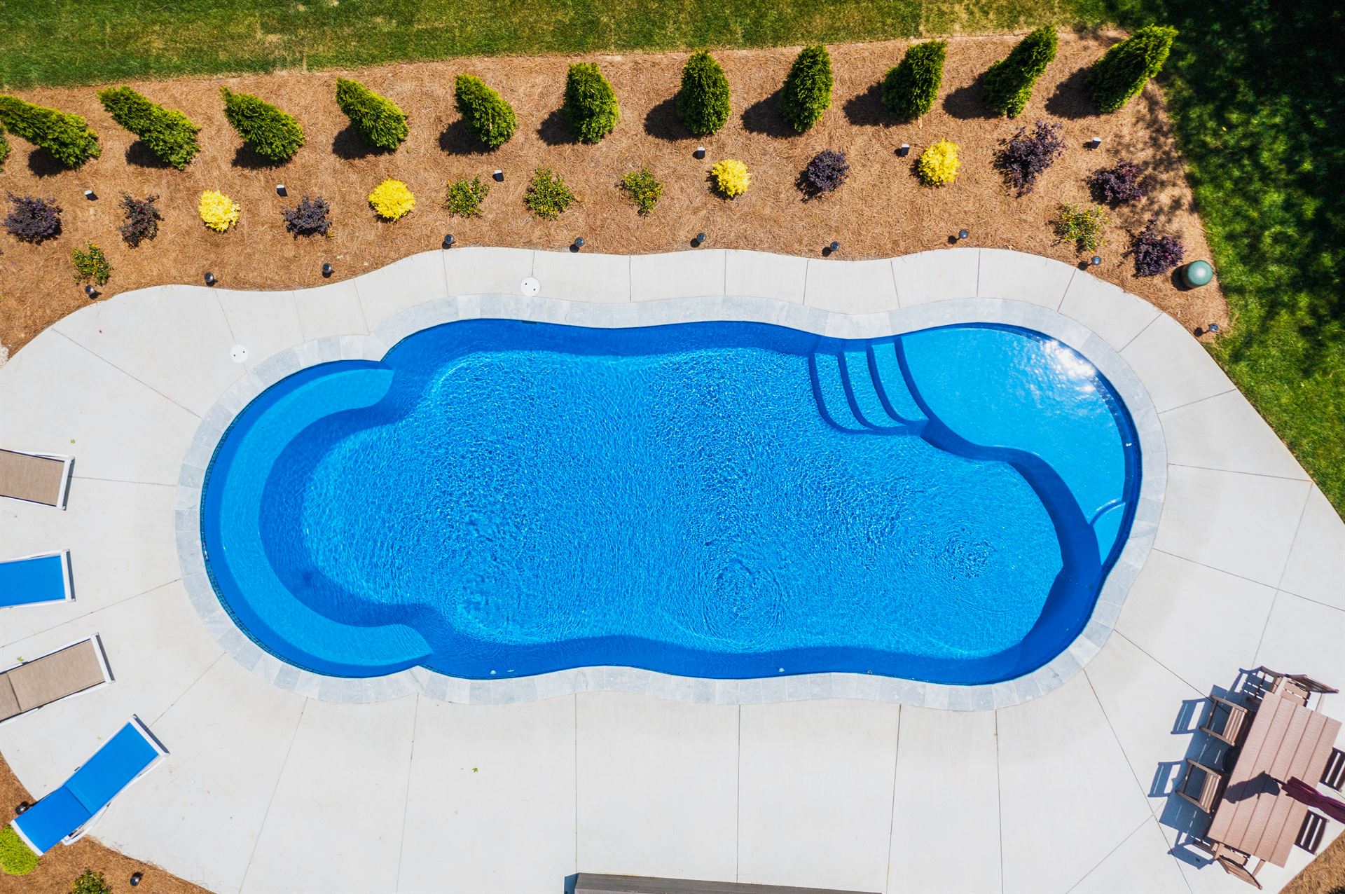 River Pools C40 in Maya Shimmer with brushed concrete and natural stone coping