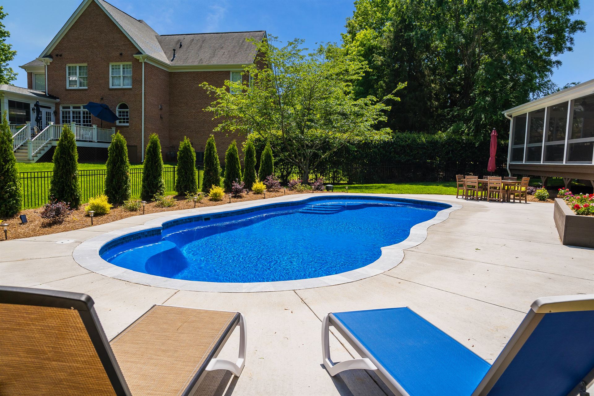 River Pools C40 in Maya Shimmer with brushed concrete and natural stone coping