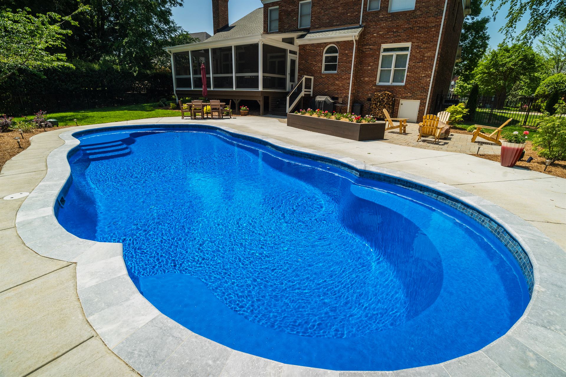 River Pools C40 in Maya Shimmer with brushed concrete and natural stone coping