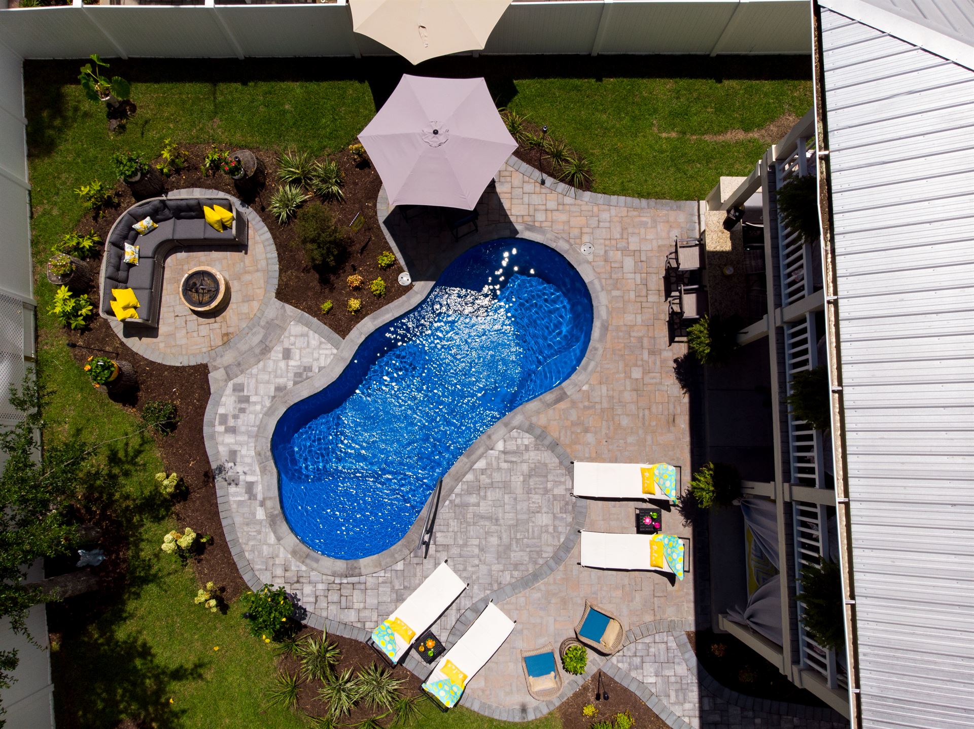 River Pools I25 in Maya Shimmer with concrete paver patio and coping