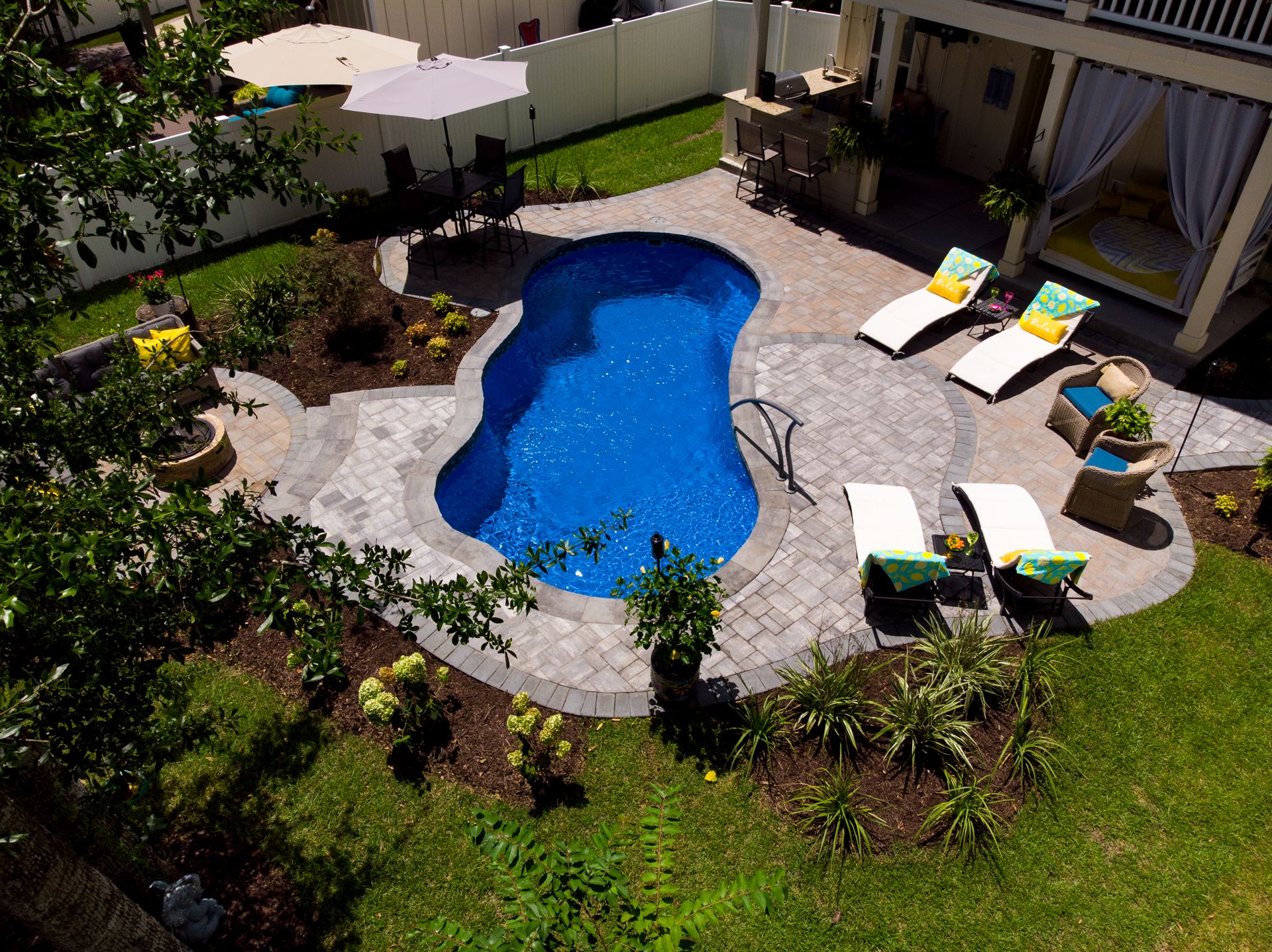 River Pools I25 in Maya Shimmer with concrete paver patio and coping