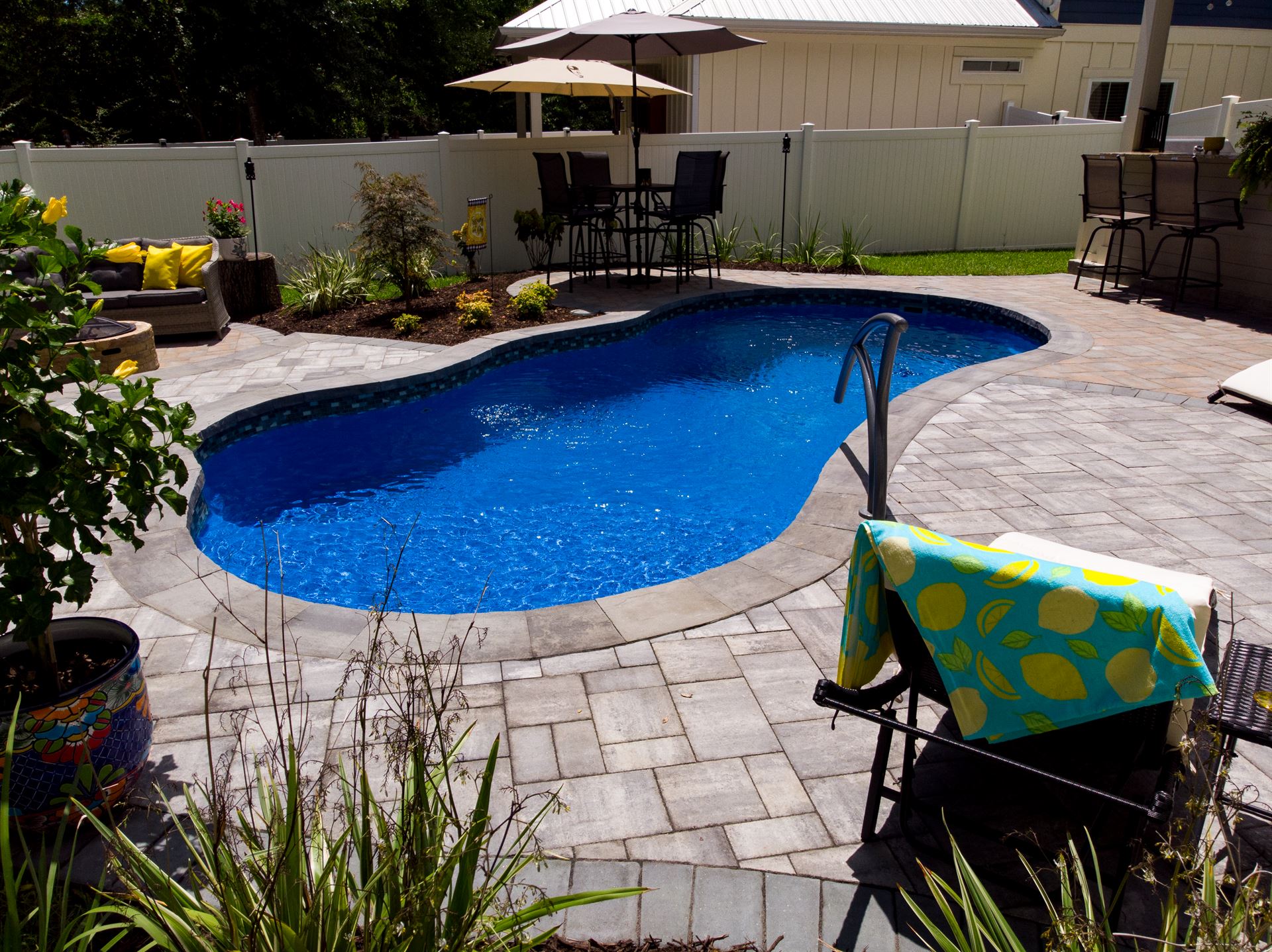River Pools I25 in Maya Shimmer with concrete paver patio and coping